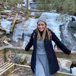 woman standing in front of waterfall