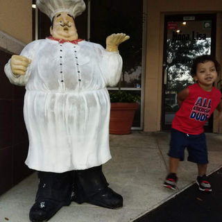 Boy standing outside of Monalisa restaurant in Fort Myers, Florida