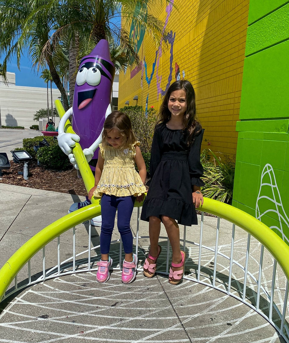 girls sitting outside at crayola experience