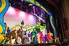 Actors on stage in colorful costumes performing Seussical the Musical.