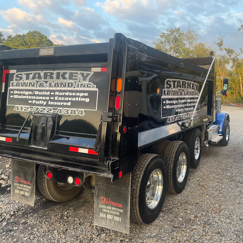 Starkey Lawn & Land Inc. hauling trucks for landscaping services.