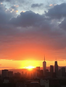 A city skyline with the sunrise in the b