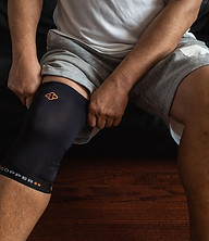 someone wearing a copper 88 knee sleeve