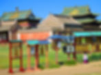 Girl spins prayer wheel at temple