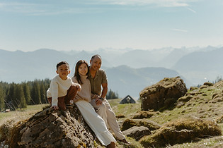 Family sitting on a rock in Switzerland