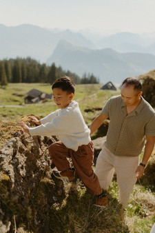 Kids playing in the mountain meadows during a natural family photoshoot in Switzerland