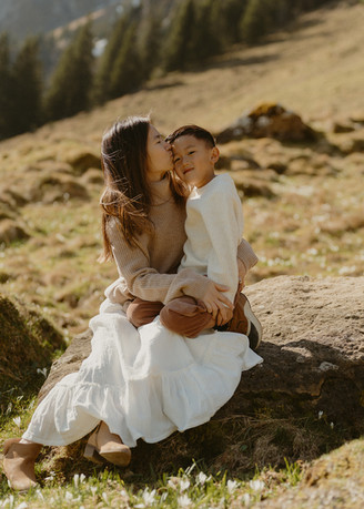 mom and son cuddling on a rock on Mt. Pilatus