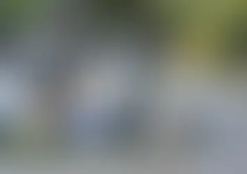 Piles of discarded boxes and old electronics placed on a residential sidewalk for bulk trash collection.