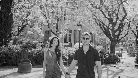 A couple enjoying their special moment beneath the towering spires of Sagrada Família
