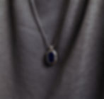 Sterling silver octagon pendant with sapphire enamel center on a silver chain.