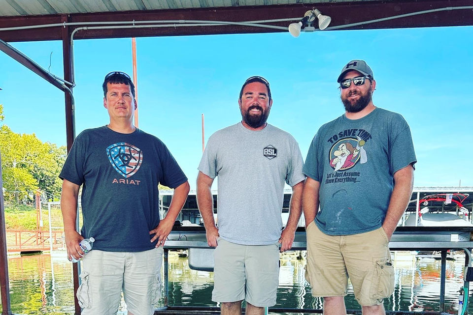 Three men on the fishing dock.