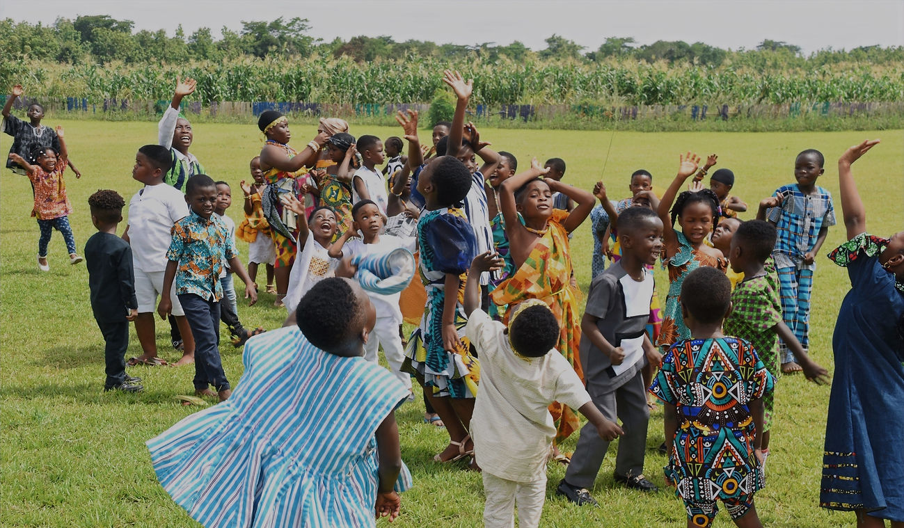 School children smiling and waving