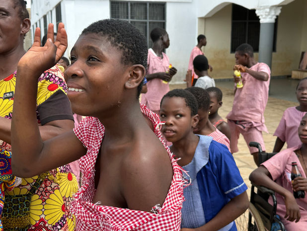 special needs student waving and smiling