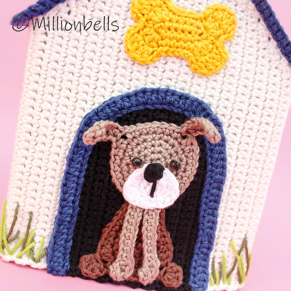 Thumbnail: Detail of crochet dog applique and yellow bone on dog house front