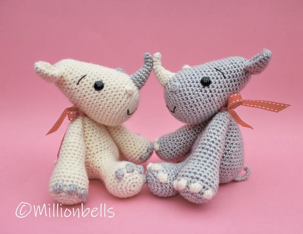 Thumbnail: 2 Crocheted rhinos in sitting position, touching noses