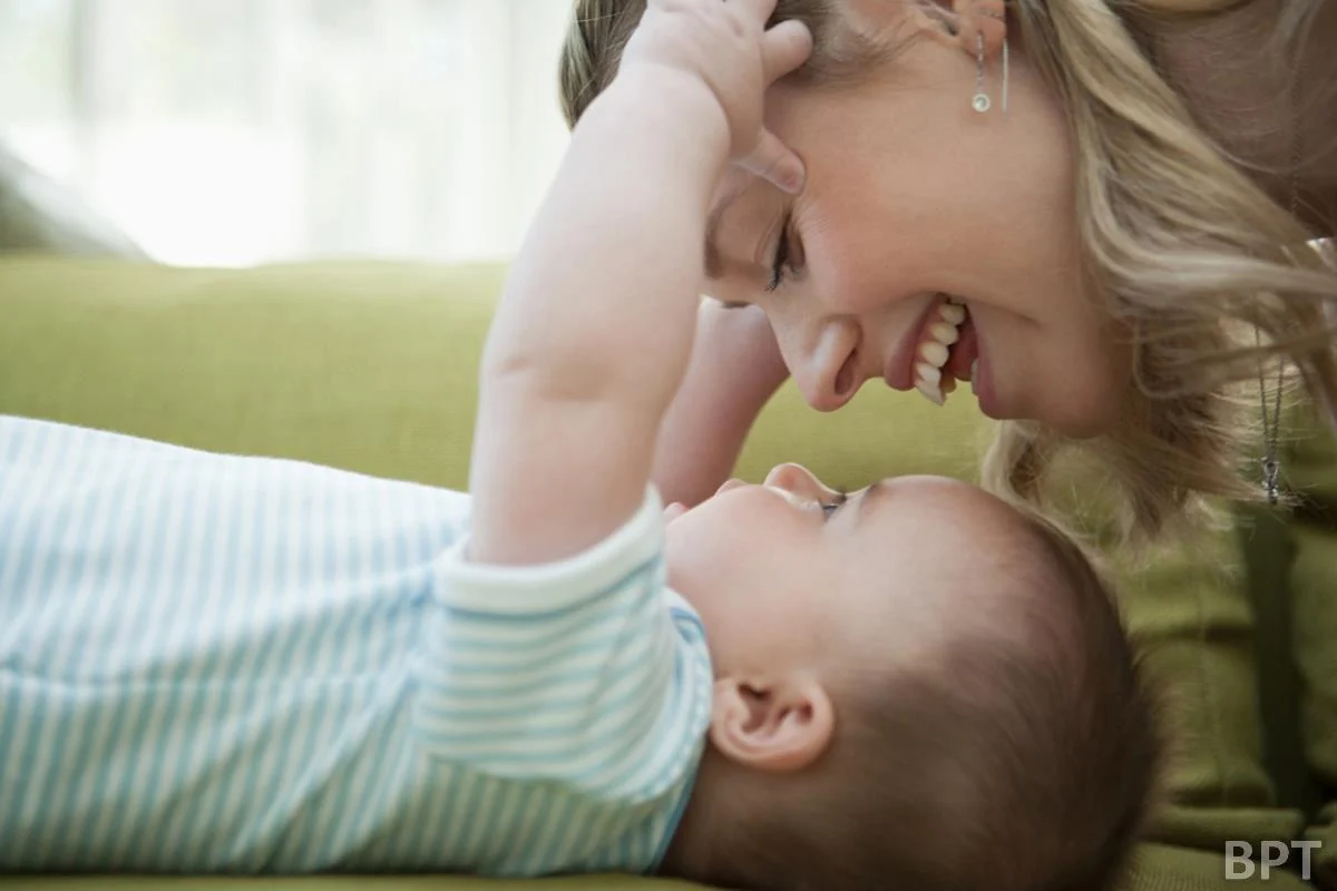 Mother and baby laying down looking in to each others' eyes
