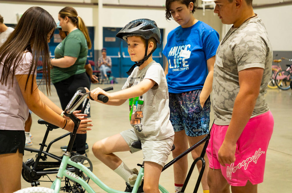 Children gain confidence and independence as they learn to ride bikes with the support of volunteers at the iCan Bike Nevada program on June 17, 2025. (Nevada Center for Excellence in Disabilities/Courtesy)