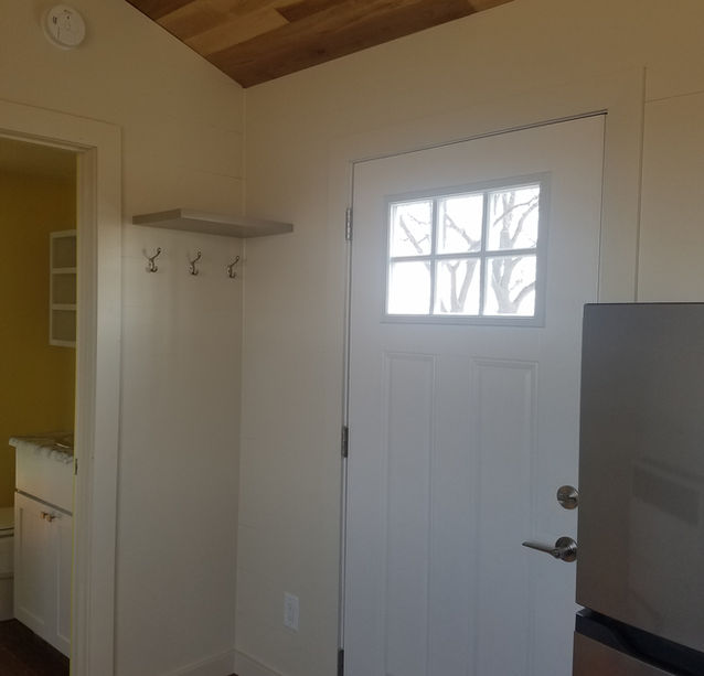 custom built tiny house, front door tiny home, wood flooring