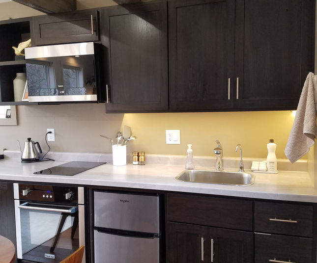 Emerald Little Lodge Tiny House Kitchen With Reclaimed Wood Beams Tiny Living Vacation Rental Driftless Rural Wooded