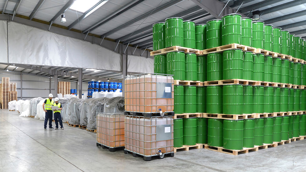 A chemical storage facility with green barrels