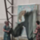 Revealing a huge painting at an art exhibition