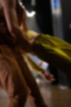 Close up of dances in a lift. all we see is torso and arms