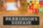 Hands writing on a notepad, surrounded by colorful fruits and veggies, yellow measuring tape, and a chalkboard with "Parkinson's Disease."