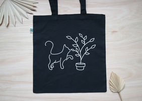 Zwart tasje met kat en plant