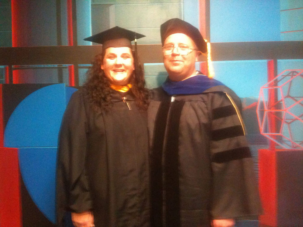 Pictured: Fawn O'Breitzman and Dr. Jeff Ogle (our karaoke host!) in graduation gowns