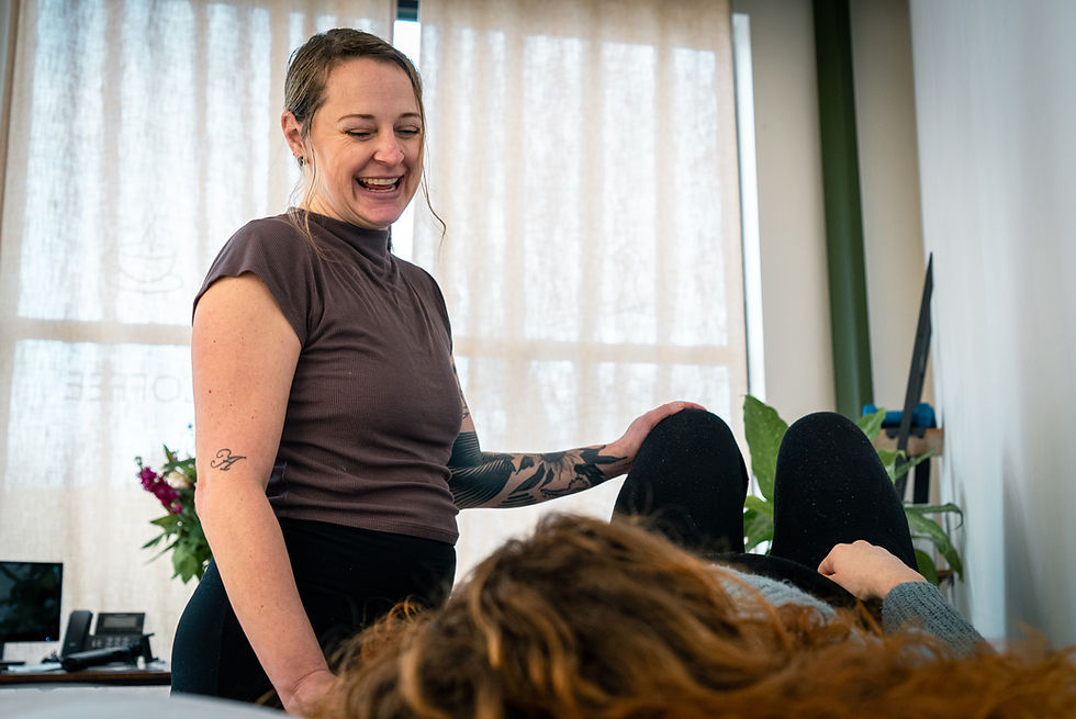 Eye-level view of a physical therapist guiding a patient through a personalized exercise in a bright Richmond clinic
