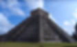 The towering Mayan ruins of Chichen Itza on a clear, sunny day.