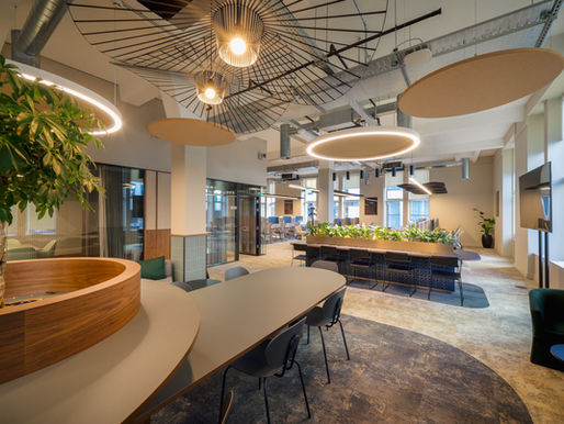 Office interior design Manchester workspace with collaborative breakout area, feature lighting, planting and modern workplace layout