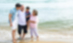 Japanese family together wading in the ocean