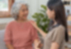 Young woman comforts elderly Asian woman