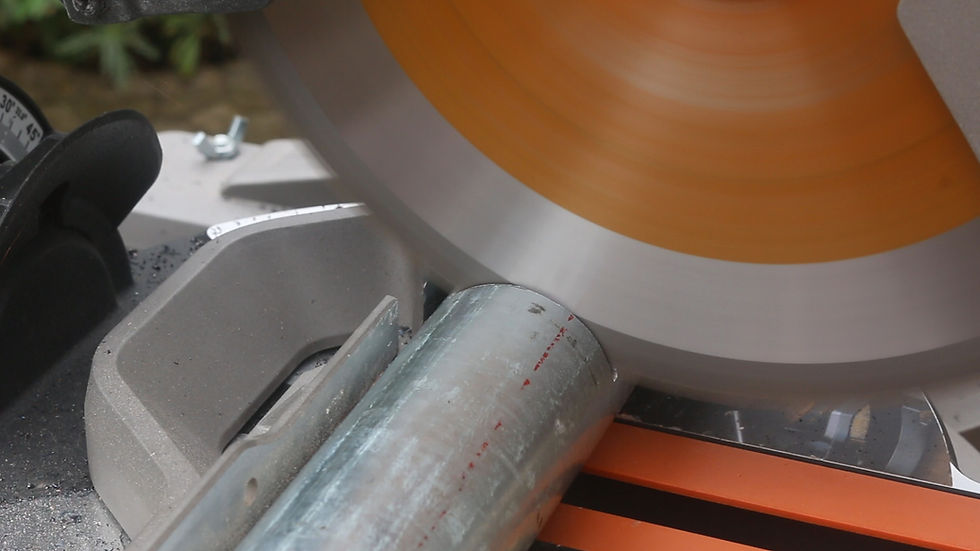Cutting a piece of scaffold tube clamp tube on an Evolution mitre saw