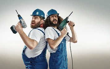 Funny portrait of two cheerful craftsmen