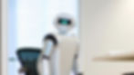 A robot in an office space, starting directly at the viewer