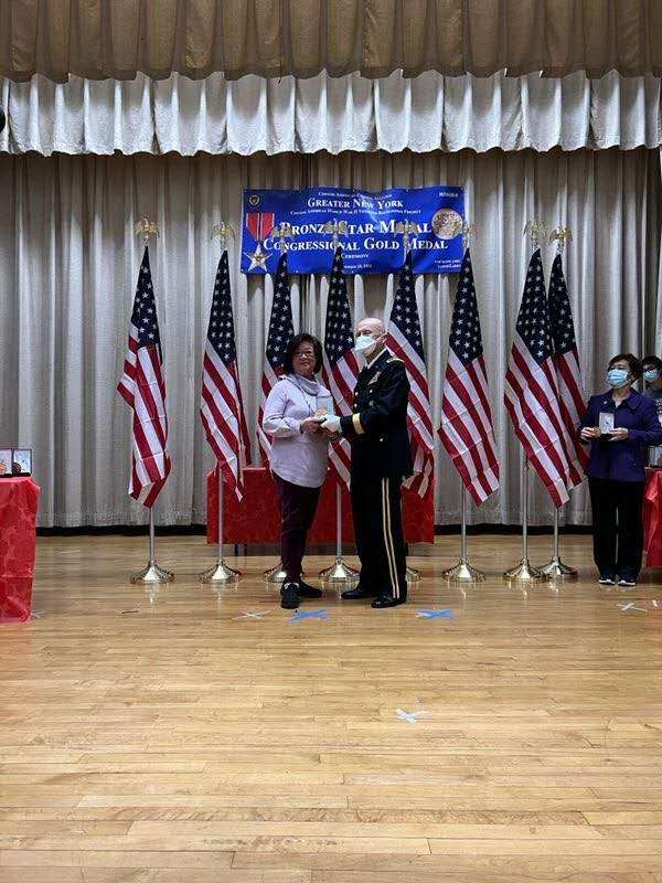 Amy Nee accepting her father's Congressional Gold Medal.