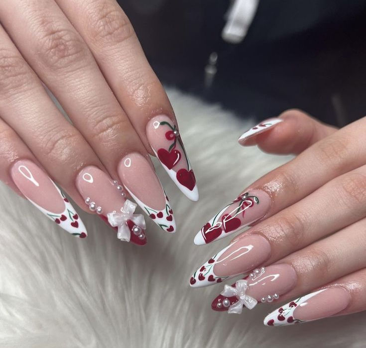long stiletto nails with white french and cherries decoration manicure
