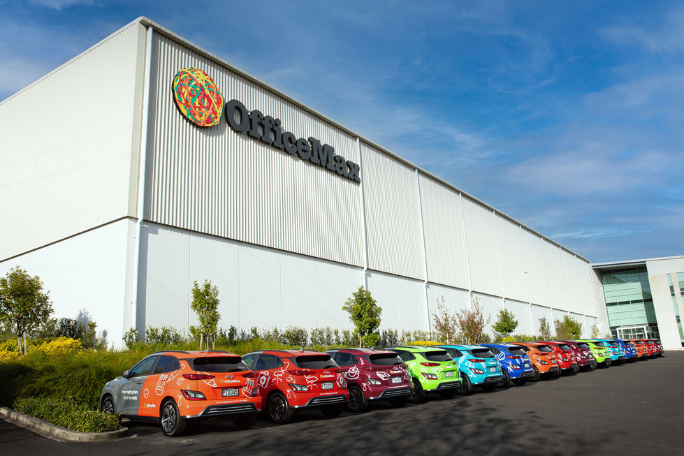 OfficeMax EV fleet outside head office sign