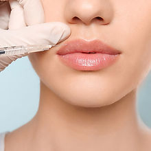 Administering lip filler for fuller, more defined lips at Pretty in Ink Cosmetics