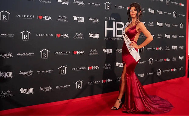 Alexine Southwood, founder of Pretty in Ink Cosmetics, on the red carpet at the 2024 Hair and Beauty Awards in a red satin evening dress with a long train