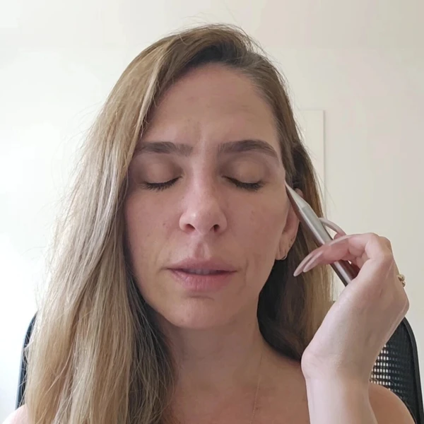 a woman demonstrate how to heal ance with the magic pen and facial reflexology
