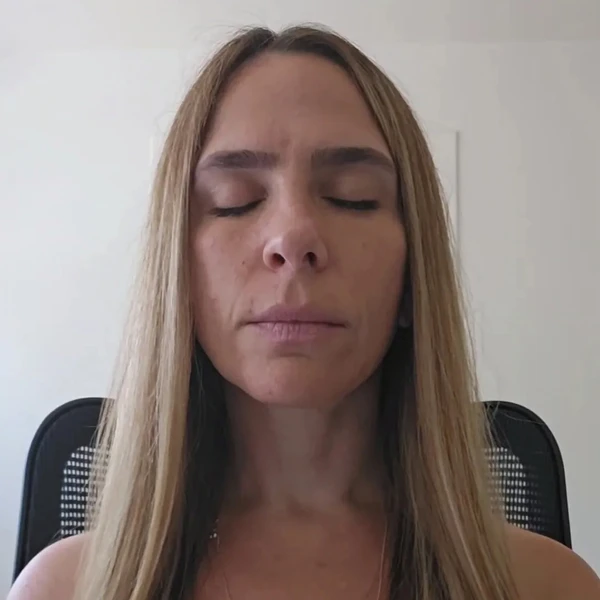 Sanadora workshop guide demonstrating emotional healing with hands over heart during a Period Relief reflexology session