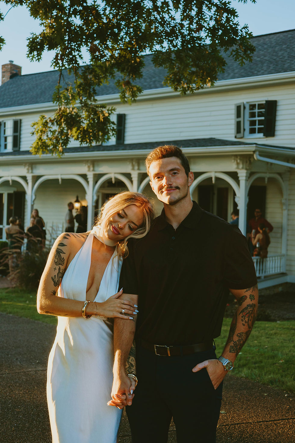 Couple enjoying golden hour outside a Tennessee farmhouse during their wedding weekend.