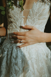 Close-up of wedding dress details and engagement ring during portraits
