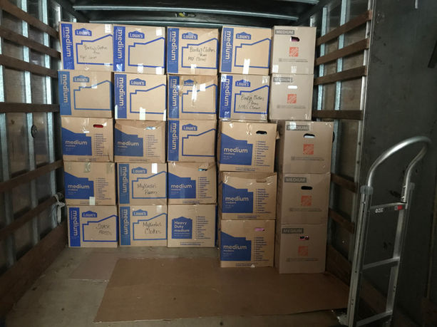 Moving truck loaded with boxes and stacked efficiently to maximize space.