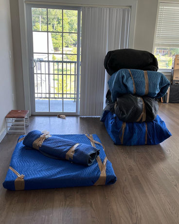 Dining room table and furniture wrapped and protected for moving by Assured Logistics Group