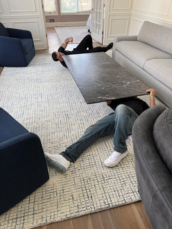 Assured Logistics Group in action disassembling a marble coffee table for moving.