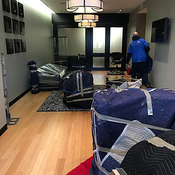 Man carrying blankets with furniture. Commercial Services.